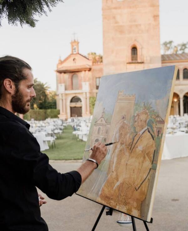Alberto Jurada pintando a los novios frente a un monasterio durante la celebración